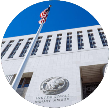 The American flag waves in front of the United States Court House.