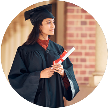 A young woman with tan skin and dark hair wears a black cap and gown and holds a diploma.